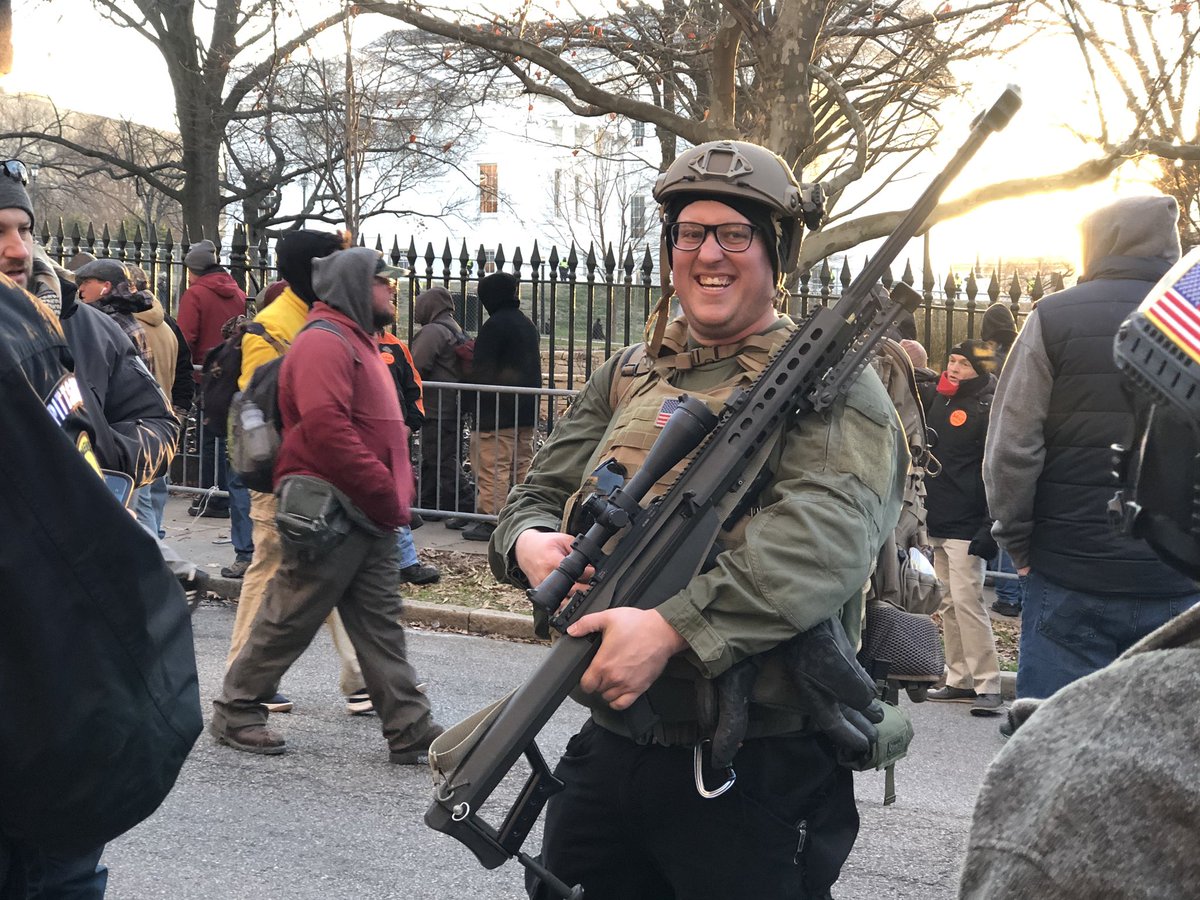 Per the @GovernorVA order, no one is armed on Capitol grounds. But a majority of people on the surrounding streets are carrying. This man, carrying a .50 cal sniper rifle, smiled for photos with other protesters #13NewsNow