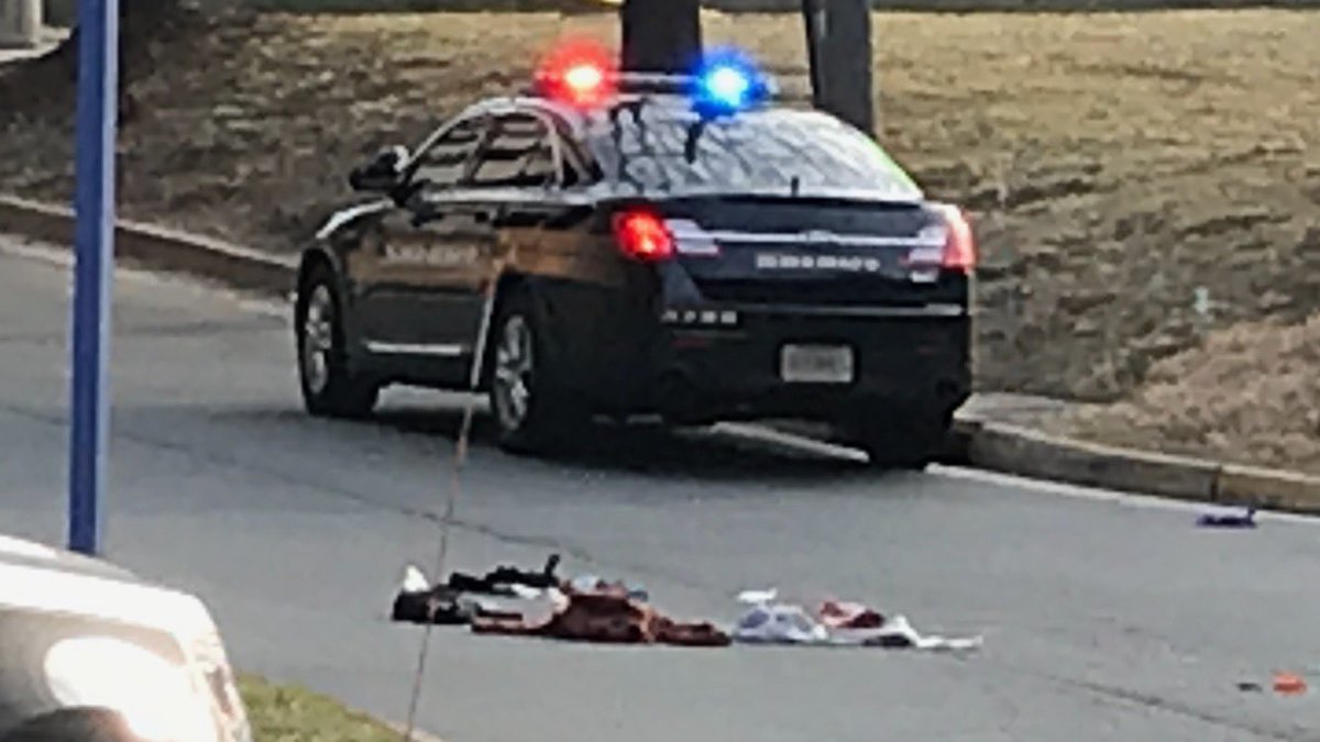 The scene outside the Fairfax County Courthouse where a man was shot in the parking garage, taken to the  hospital in critical condition. Police have swarmed the area looking for the suspect. The courthouse & its campus are locked down