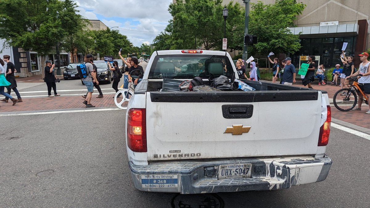 Even though the march is on the sidewalk, this driver and his passenger is upset with the constant flow of pedestrians blocking the road. Eventually they take a different road