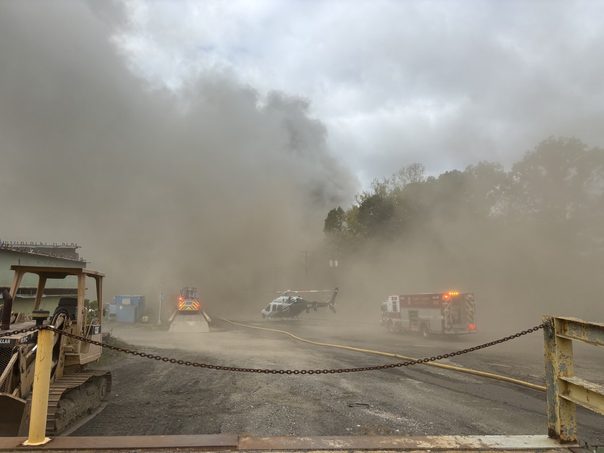 FCFRD is on scene of a 2-alarm outside fire in the 9900 blk of Richmond Hwy in Lorton. Units arrived to a large recycling pile on fire & a person trapped in a crane. Crews rescued the crane occupant& are working to bring the fire under control. 1 civilian & 1 FF transported